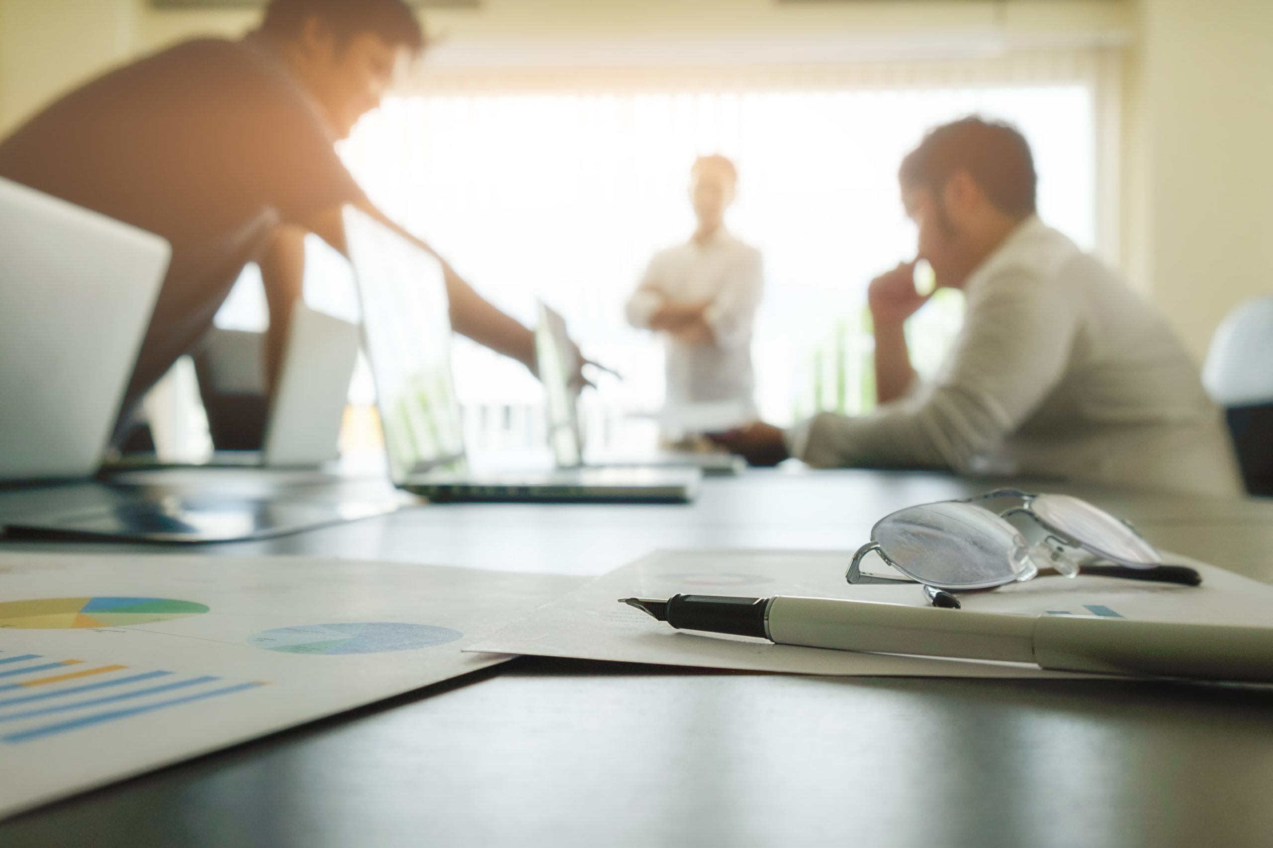business concept with copy space office desk table with pen focus analysis chart computer notebook cup coffee desk vintage tone retro filter selective focus scaled
