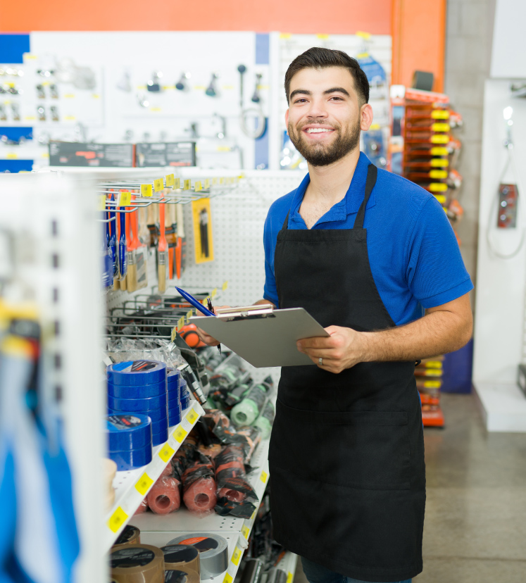 retail worker smiling with clipboard