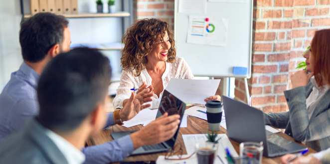 group of office workers sitting around table