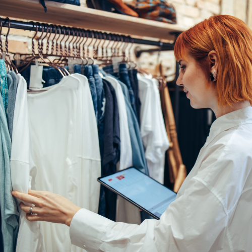 retail worker inspecting clothes 